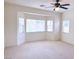 Spacious living room featuring large windows offering natural light and neutral carpeting at 4695 E Lucera Ct, Pahrump, NV 89061