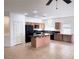 Well-lit kitchen featuring an island with granite countertop and stainless steel appliances at 4695 E Lucera Ct, Pahrump, NV 89061