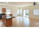 Bright kitchen area with center island, tile floors, and sliding glass doors to the backyard at 4695 E Lucera Ct, Pahrump, NV 89061