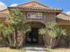 Charming pro shop building with stone facade, arched entrance, and lush landscaping, offering a premium golf experience at 4695 E Lucera Ct, Pahrump, NV 89061