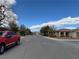 Residential street view with a red truck parked and well-kept homes showcasing the tranquil neighborhood setting at 4695 E Lucera Ct, Pahrump, NV 89061