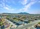 Breathtaking aerial view of a residential area, showcasing houses and the distant mountain range at 4708 Thunderbolt Ave, Las Vegas, NV 89115
