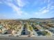 Scenic aerial view of a residential community with mountain backdrop and clear blue skies at 4708 Thunderbolt Ave, Las Vegas, NV 89115