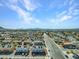 Expansive aerial view featuring a residential area and distant mountains under a clear blue sky at 4708 Thunderbolt Ave, Las Vegas, NV 89115