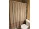 Standard bathroom with a toilet and shower with patterned curtain at 4708 Thunderbolt Ave, Las Vegas, NV 89115