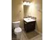 Standard bathroom with a toilet, sink, and vanity, all illuminated by a light fixture above the mirror at 4708 Thunderbolt Ave, Las Vegas, NV 89115