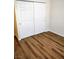Bedroom with wood floors and a white closet with sliding doors at 4708 Thunderbolt Ave, Las Vegas, NV 89115