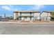 Two-story apartment building featuring balconies, a small yard, and secured by a chain-link fence at 4708 Thunderbolt Ave, Las Vegas, NV 89115