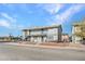 Angle view of a 2 story apartment building with balconies, secured chain link fence and gravel at 4708 Thunderbolt Ave, Las Vegas, NV 89115