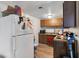 A view of the kitchen with older wooden cabinets and an white refrigerator at 4708 Thunderbolt Ave, Las Vegas, NV 89115