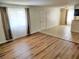 Bright living room showcasing hardwood floors, large windows, and seamless flow to the kitchen at 4708 Thunderbolt Ave, Las Vegas, NV 89115