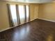 A living room with wood floors, a door, and a window with translucent curtains at 4708 Thunderbolt Ave, Las Vegas, NV 89115