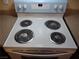 White electric stove top with four burners and blue control panel at 4708 Thunderbolt Ave, Las Vegas, NV 89115