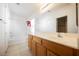 Well-lit bathroom featuring a wide mirror, oak cabinets, and a shower-tub combo at 4847 Double Down Dr # 101, Las Vegas, NV 89122