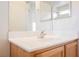 Bathroom vanity features white countertops, wooden cabinetry, and a framed mirror at 4847 Double Down Dr # 101, Las Vegas, NV 89122