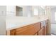 Bright bathroom featuring a large counter space, wood cabinets, and a neutral design at 4847 Double Down Dr # 101, Las Vegas, NV 89122