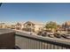 A neighborhood view from the balcony shows the tree-lined street and houses at 4847 Double Down Dr # 101, Las Vegas, NV 89122