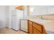 Functional kitchen with white appliances, tile flooring, and wooden cabinetry at 4847 Double Down Dr # 101, Las Vegas, NV 89122