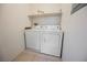The laundry room has a side-by-side washer and dryer and shelving above at 4847 Double Down Dr # 101, Las Vegas, NV 89122