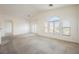 Open living room featuring carpet, large windows, and neutral walls at 4847 Double Down Dr # 101, Las Vegas, NV 89122