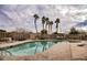 Inviting community swimming pool with comfortable lounge chairs under palm trees at 4847 Double Down Dr # 101, Las Vegas, NV 89122