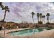 Relaxing community pool area with tall palm trees and lounge chairs at 4847 Double Down Dr # 101, Las Vegas, NV 89122