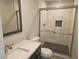 Bathroom with a white marble vanity, tiled shower with glass doors, and stone floor at 4905 Danbrook Ct, Las Vegas, NV 89110
