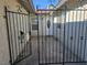 Ornate metal gate leading to the front door with white trim and glass insert at 4905 Danbrook Ct, Las Vegas, NV 89110