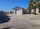 Single-story home featuring a driveway, desert landscaping, and gated front entrance at 4905 Danbrook Ct, Las Vegas, NV 89110