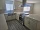Updated kitchen featuring stainless steel appliances, island cooktop, and ample counter space at 4905 Danbrook Ct, Las Vegas, NV 89110