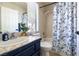 Cozy bathroom featuring blue and white decor, a shower/tub combo, and a vanity at 4923 Strauss Dr, Las Vegas, NV 89146