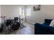 Bright room with drum set, sleek gray flooring, and a comfortable blue sofa at 4923 Strauss Dr, Las Vegas, NV 89146