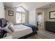 Bright bedroom featuring an arched window, wood flooring, and comfortable decor at 4923 Strauss Dr, Las Vegas, NV 89146