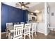 Dining room featuring a modern table, ample seating, and decorative wall paneling at 4923 Strauss Dr, Las Vegas, NV 89146