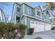 Beautiful townhouse featuring a two-car garage and manicured landscaping at 4923 Strauss Dr, Las Vegas, NV 89146