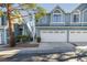 Charming townhouse featuring a two-car garage, and lush landscaping at 4923 Strauss Dr, Las Vegas, NV 89146