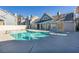 Community pool and spa area, surrounded by blue buildings and concrete patio at 4923 Strauss Dr, Las Vegas, NV 89146