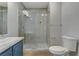 Bathroom featuring tile shower, toilet and vanity with sink and stylish cabinets at 501 Tuscany View St, Las Vegas, NV 89145