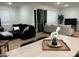 Open-concept living area featuring sleek black sofa and seamless access to the outdoor space at 5230 Lissome Lily Ct, Las Vegas, NV 89139
