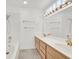 Bathroom featuring double sink vanity, tub, shower and ample natural light at 5421 Painted Mirage Rd, Las Vegas, NV 89149