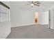 Spacious bedroom with neutral carpet, a ceiling fan, and an en-suite bath at 5421 Painted Mirage Rd, Las Vegas, NV 89149