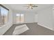 Bright bedroom featuring neutral carpet, a ceiling fan, and access to a balcony at 5421 Painted Mirage Rd, Las Vegas, NV 89149