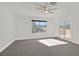 Bright bedroom featuring neutral carpet, a ceiling fan, and access to a balcony at 5421 Painted Mirage Rd, Las Vegas, NV 89149