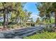 Gated community entrance with lush landscaping, mature trees, and well-maintained surroundings, ensuring privacy and security at 5421 Painted Mirage Rd, Las Vegas, NV 89149