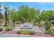 Community entrance sign with the name 'Painted Desert', surrounded by desert landscaping and mature trees at 5421 Painted Mirage Rd, Las Vegas, NV 89149
