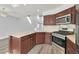 Modern kitchen featuring stainless steel appliances, wood cabinets and a spacious island at 5421 Painted Mirage Rd, Las Vegas, NV 89149