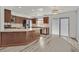 Modern kitchen featuring granite countertops, stainless steel appliances, and sleek wood cabinets at 5421 Painted Mirage Rd, Las Vegas, NV 89149
