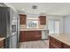 Kitchen featuring stainless steel appliances, stylish backsplash, and wood cabinetry at 5421 Painted Mirage Rd, Las Vegas, NV 89149