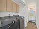 Laundry room with modern washer and dryer, bright lighting and vanity area at 5421 Painted Mirage Rd, Las Vegas, NV 89149