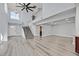 Bright and airy living space with modern flooring, high ceilings, and an open staircase at 5421 Painted Mirage Rd, Las Vegas, NV 89149